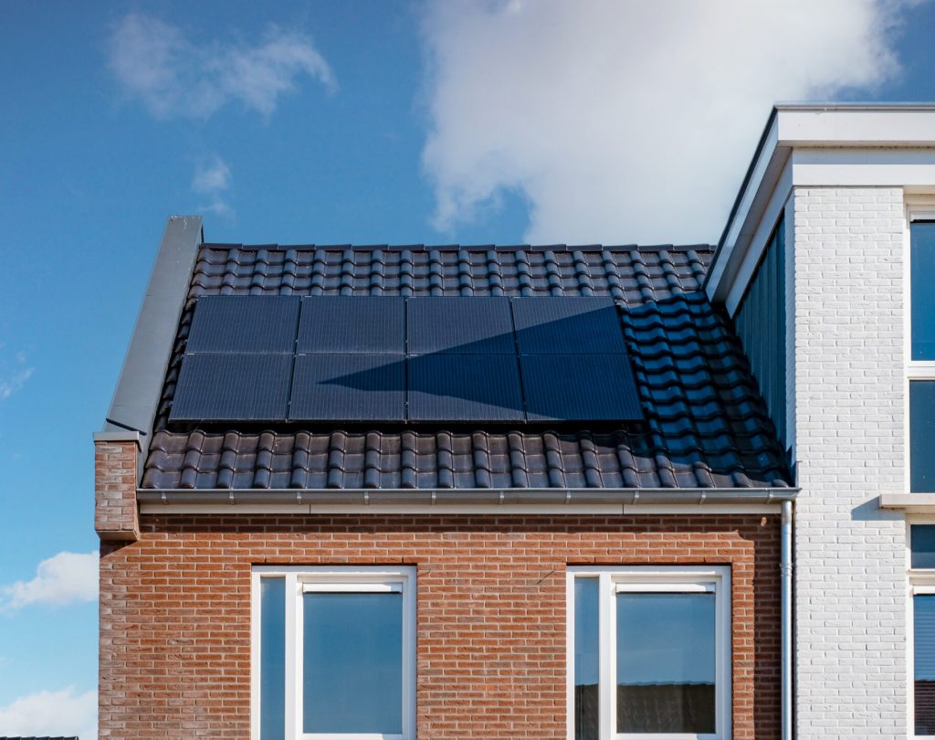 Newly build houses with solar panels attached on the roof ,Solar photovoltaic panels on a house roof